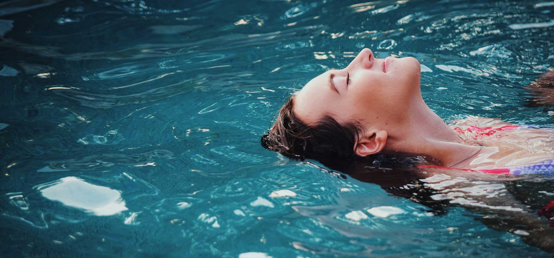 woman swimming in pool on vacation