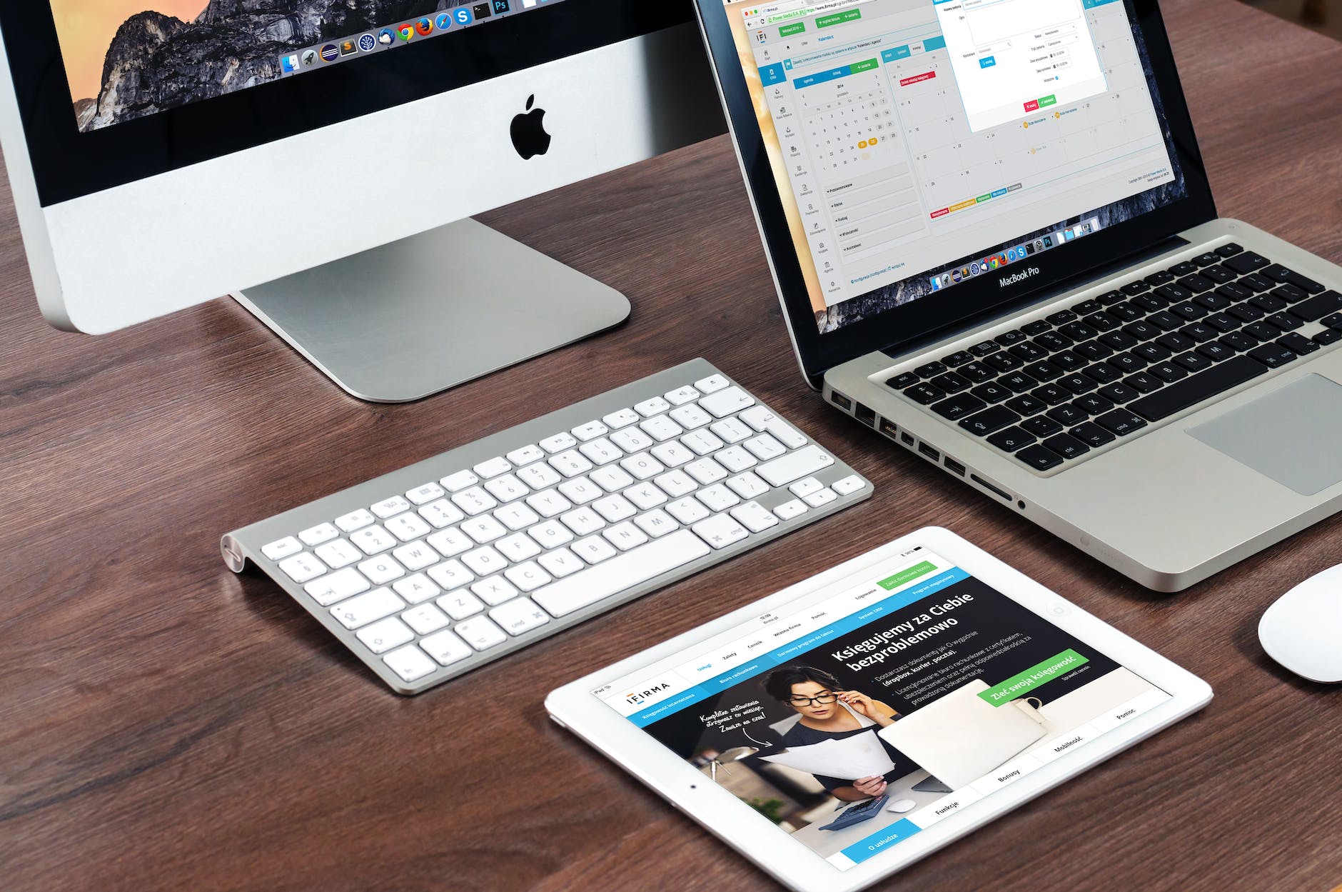 Responsive web design displayed on computer, tablet, and smartphone screens showcasing modern business website layout.